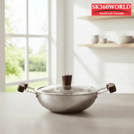 Master the Art of Indian Cooking with the NIDHI Tri-Ply Honeycomb Deep Kadhai. Upgrade your kitchen arsenal with a Kadai that blends traditional utility with modern technology. Whether you are simmering a slow-cooked Biryani or deep-frying festive snacks, our 2.5mm thick Hybrid Kadai delivers professional results right at home. Why This Kadai Stands Out: Scratch-Resistant Hybrid Tech: The unique honeycomb pattern isn’t just for looks. By raising the steel web slightly above the non-stick surface, we’ve created a pan that resists the wear and tear of metal spatulas. You get the searing power of steel with the easy release of non-stick. Built for Heat: The tri-ply construction is the gold standard for cookware. The aluminum core runs through the entire body—not just the bottom—ensuring that heat travels up the sides of the Kadhai. This means faster cooking times and energy efficiency. Healthy & Safe: Use minimal oil without food sticking or burning. Our coating is PFOA-free and non-toxic, ensuring your meals are safe for your family. Aesthetic Appeal: The combination of polished stainless steel and natural wood accents makes this Kadai a centerpiece on your dining table. Serve directly from stove to table with style.